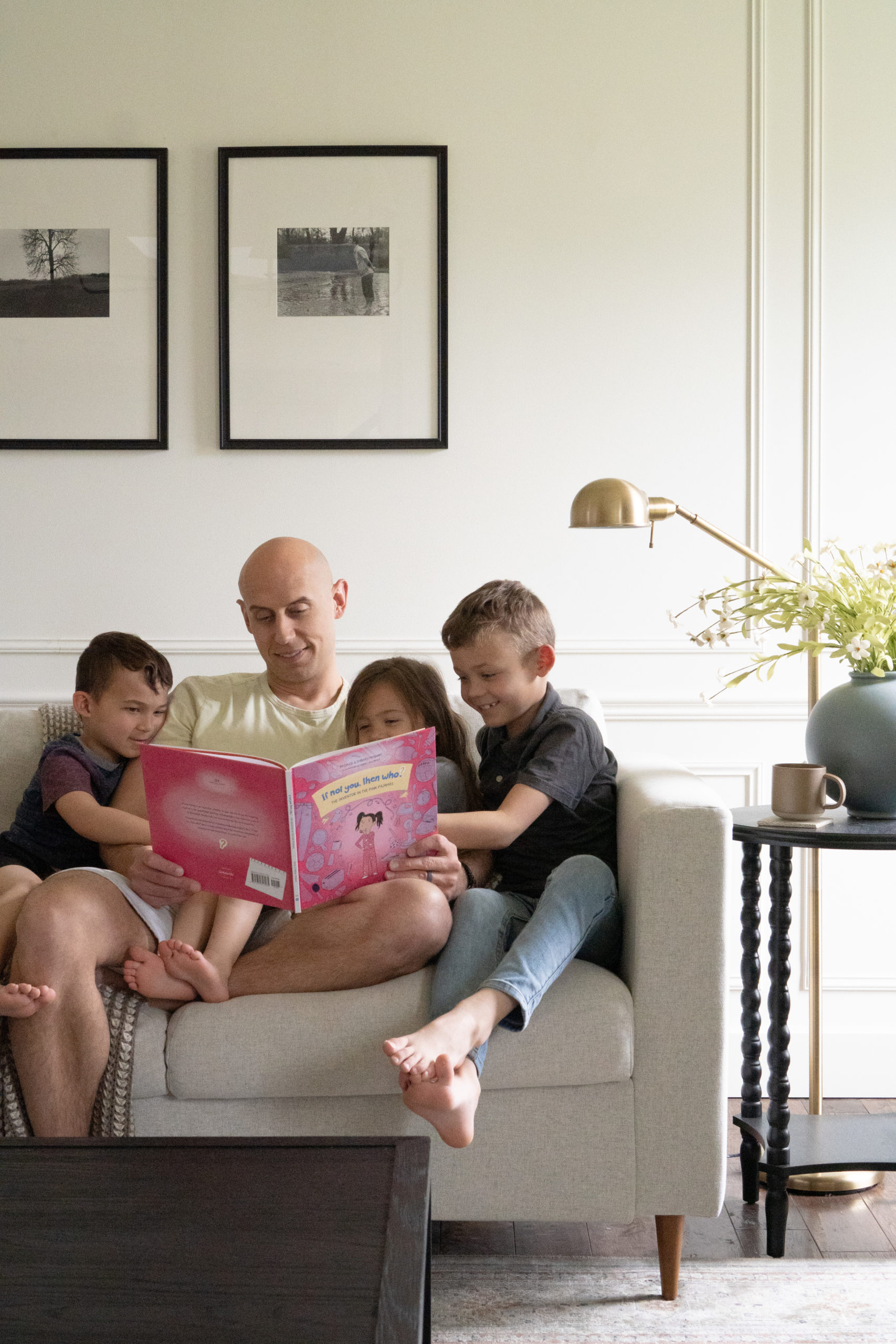 Dad and kids reading a book on the couch